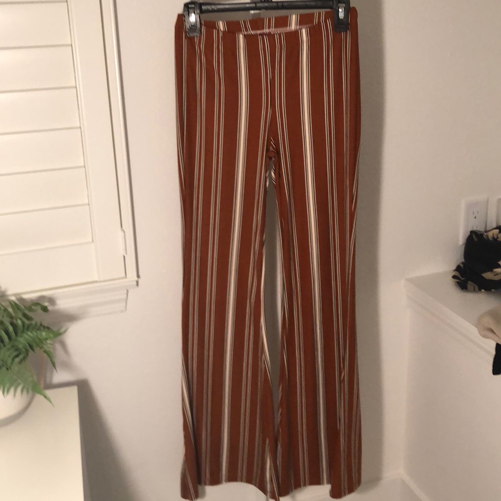 orange black and white boot cut pants